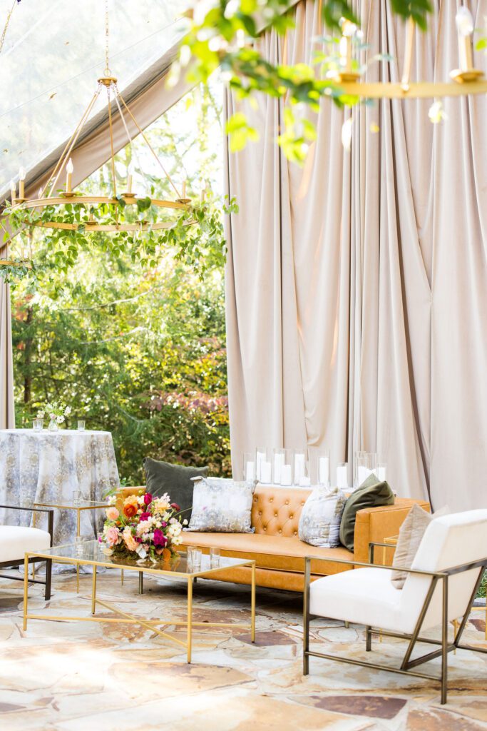 Lounge area on the patio for a backyard wedding under a tent.