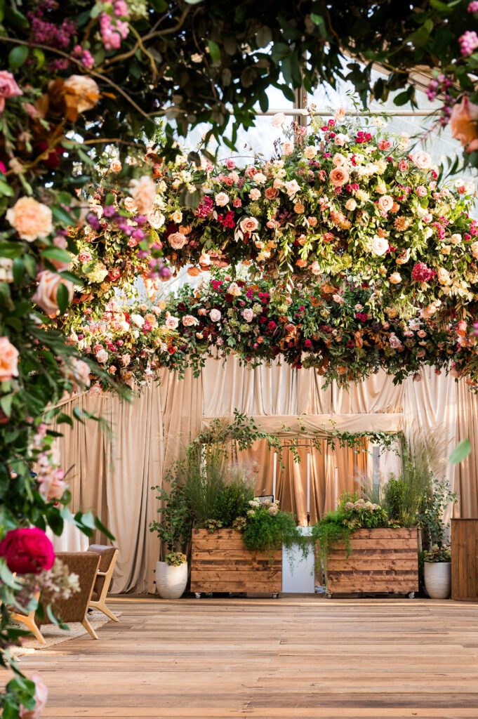 Tented backyard wedding with draping and florals in ceiling