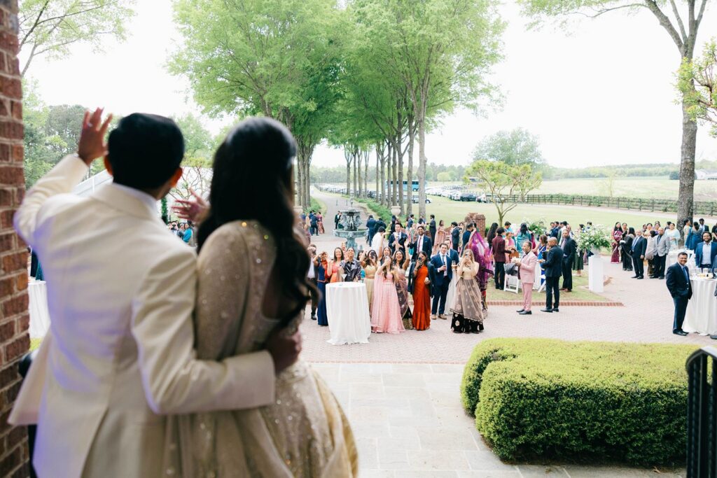 Couple waving to guests for their wedding weekend at Britton Manor.