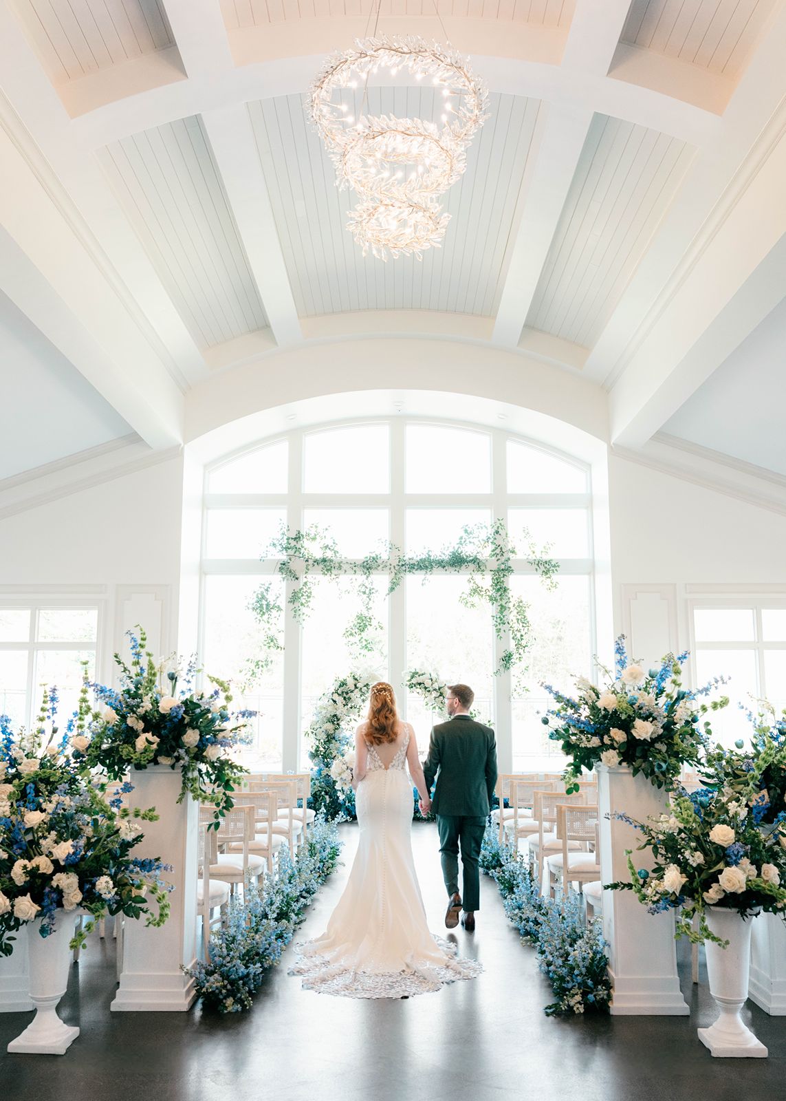 Donovan Manor wedding ceremony in Feore Hall in front of the big windows.