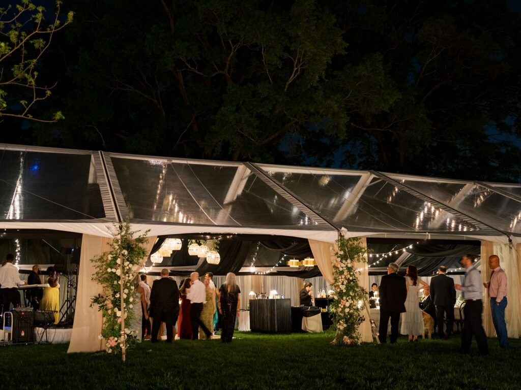 Night photo of clear top tent for wedding at Hill House in Durham, NC.