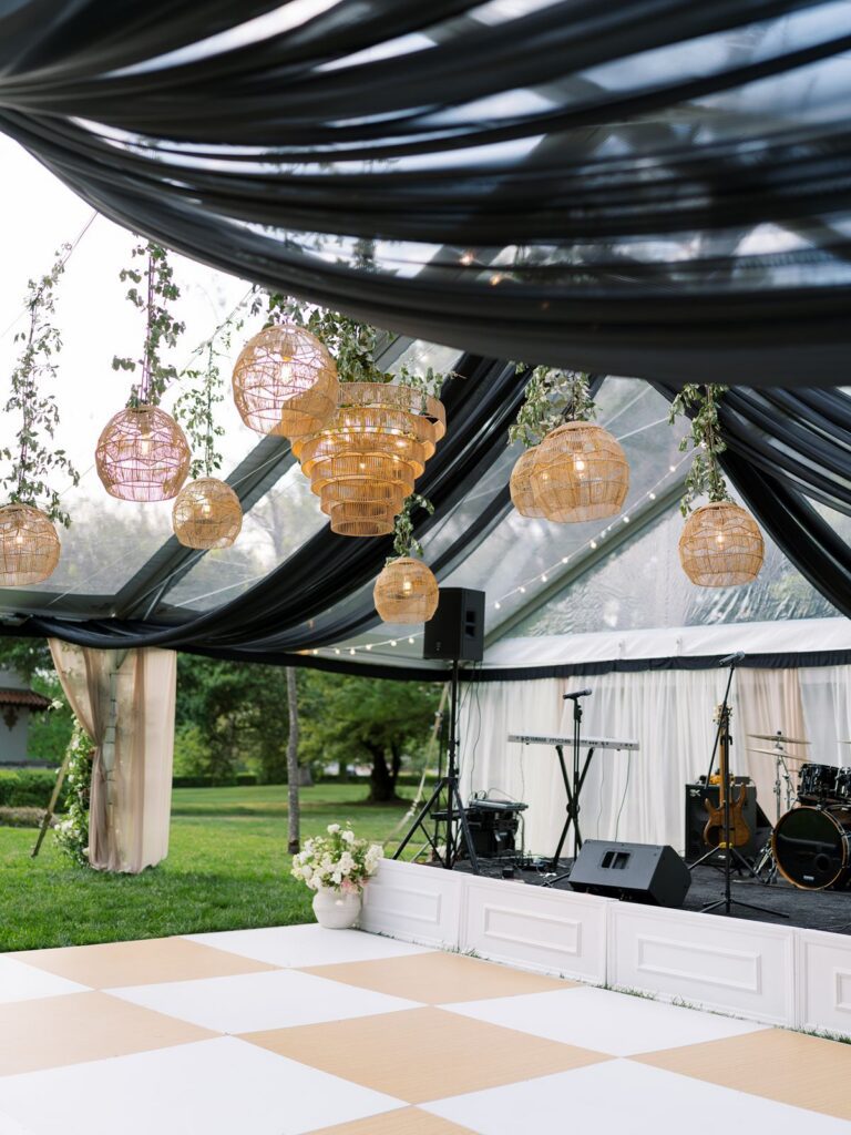 Rattan chandeliers over white and wood dance floor