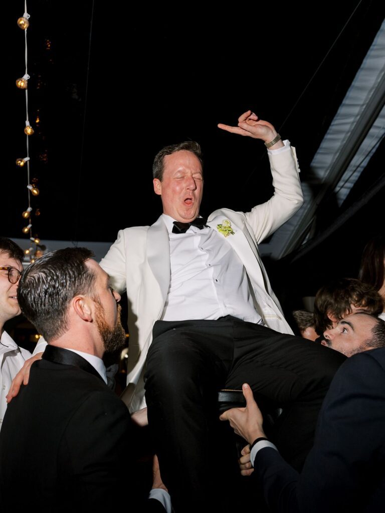 Jewish wedding Horrah groom lifted in chair