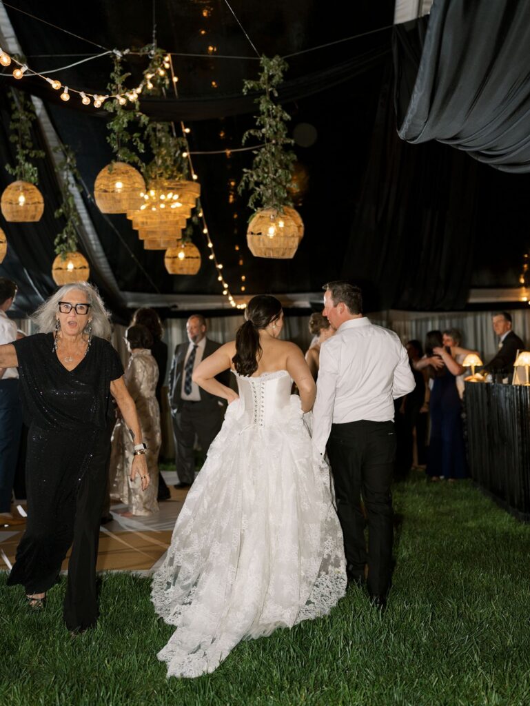 rattan chandeliers at night in clear tent