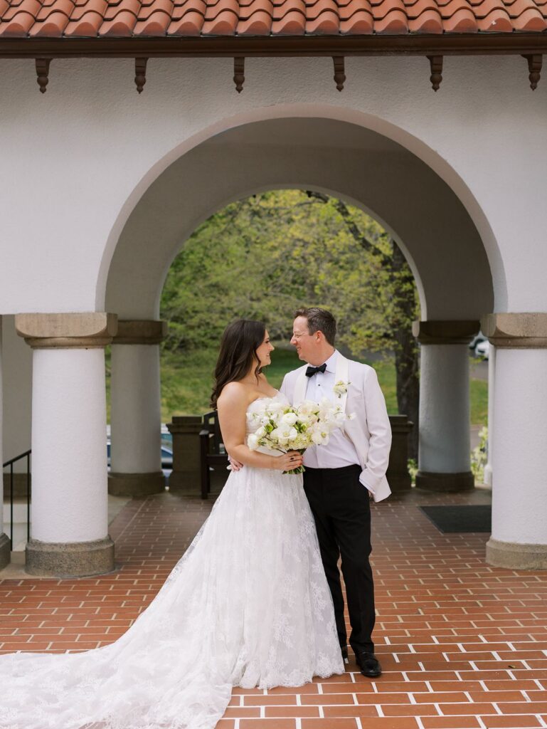 Bride and groom on the veranda at Hill House Durham.