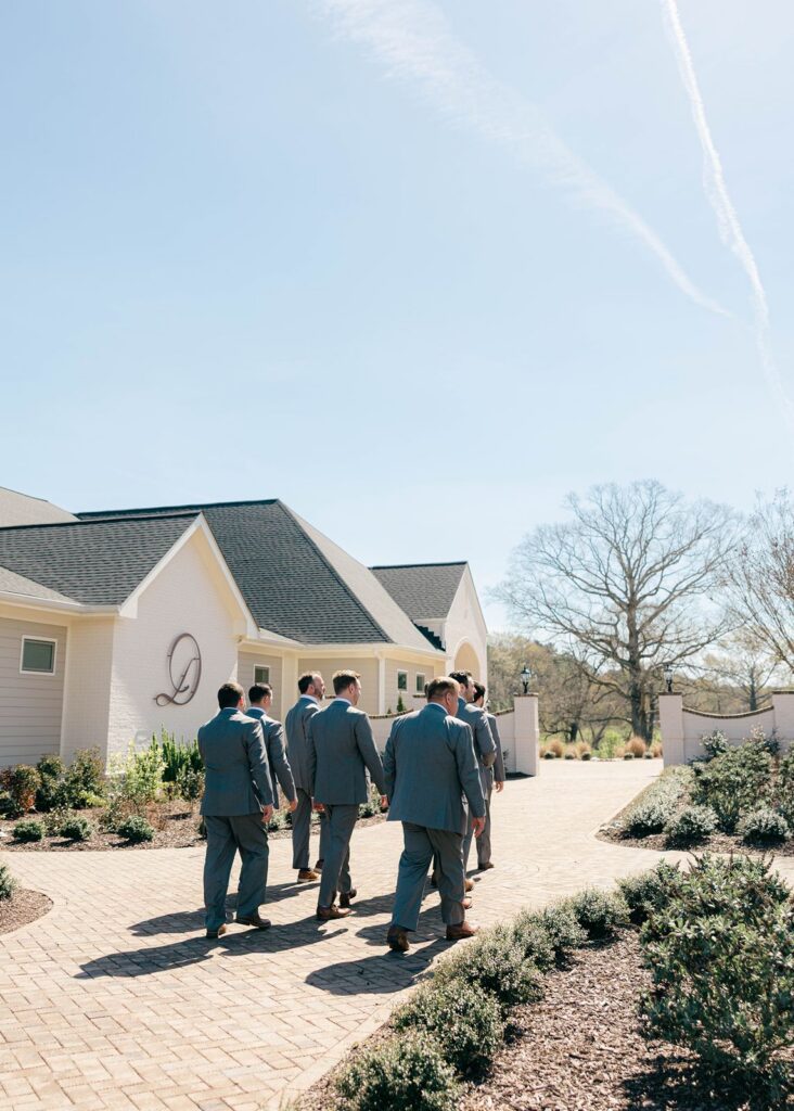 Groomsmen walking outside at Donovan Manor
