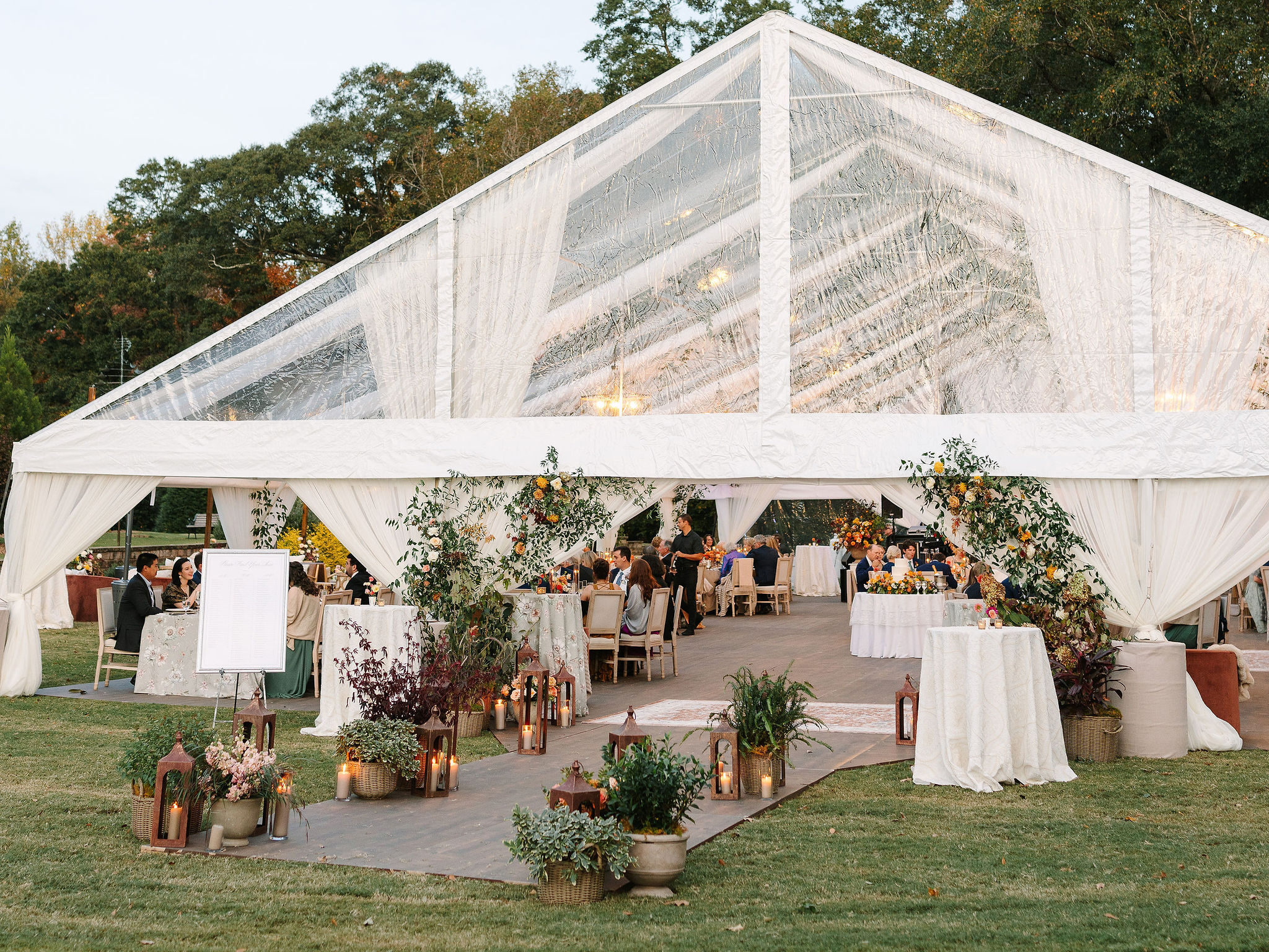 Cleartop tent with draping for a wedding in family's backyard
