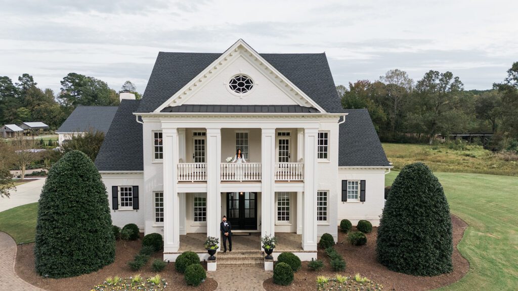 Bride and groom on porches at Donovan Manor