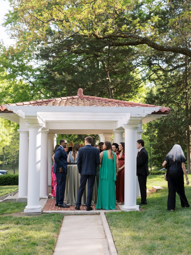 Guests mingle under the gazebo before a ceremony at Hill House